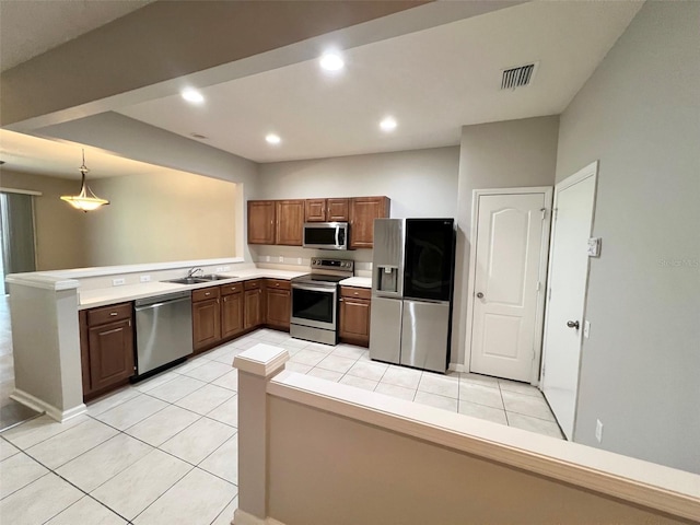26514 Chimney Spire Ln, Wesley Chapel, FL 33544 - kitchen featuring stainless steel appliances, a peninsula, light tile patterned floors, a sink, and recessed lighting