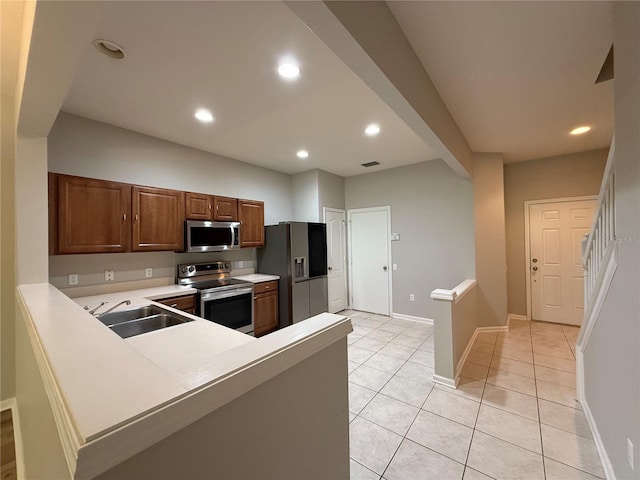 26514 Chimney Spire Ln, Wesley Chapel, FL 33544 - kitchen with appliances with stainless steel finishes, a sink, light countertops, light tile patterned flooring, and recessed lighting