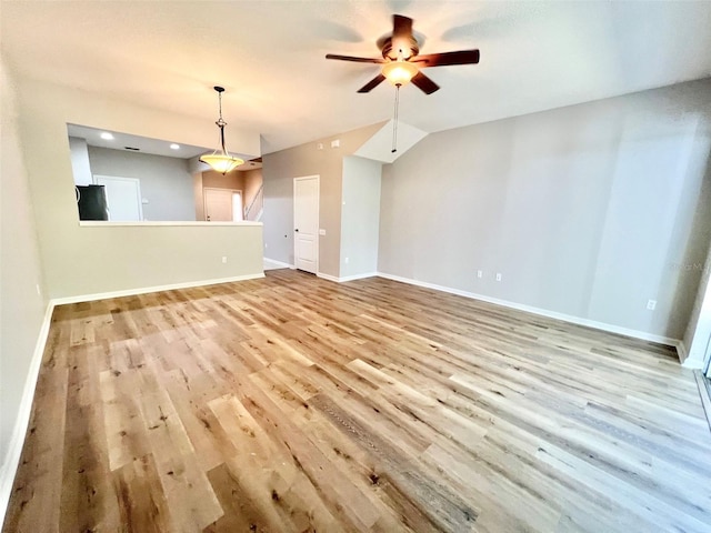 26514 Chimney Spire Ln, Wesley Chapel, FL 33544 - unfurnished living room featuring wood finished floors, ceiling fan, and baseboards