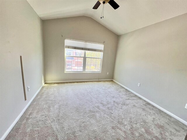 26514 Chimney Spire Ln, Wesley Chapel, FL 33544 - spare room featuring ceiling fan, carpet flooring, lofted ceiling, and baseboards
