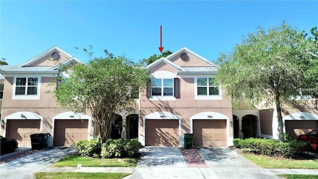 26514 Chimney Spire Ln, Wesley Chapel, FL 33544 - view of front of home with stucco siding, an attached garage, and driveway