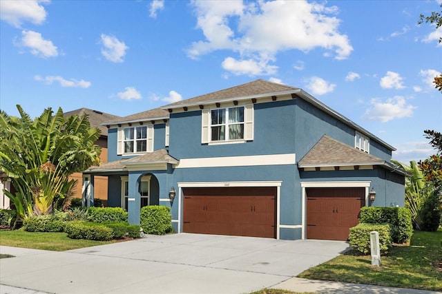 10017 Smarty Jones Dr, Ruskin, FL 33573 - view of front of house with stucco siding, concrete driveway, a garage, and roof with shingles