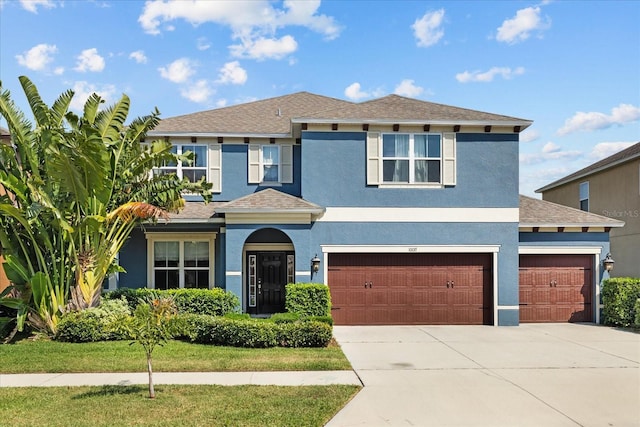 10017 Smarty Jones Dr, Ruskin, FL 33573 - view of front of home featuring stucco siding, driveway, a shingled roof, and an attached garage