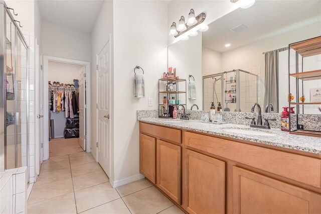 11938 Bahia Valley Dr, Riverview, FL 33579 - full bath with double vanity, a shower stall, tile patterned flooring, and a sink