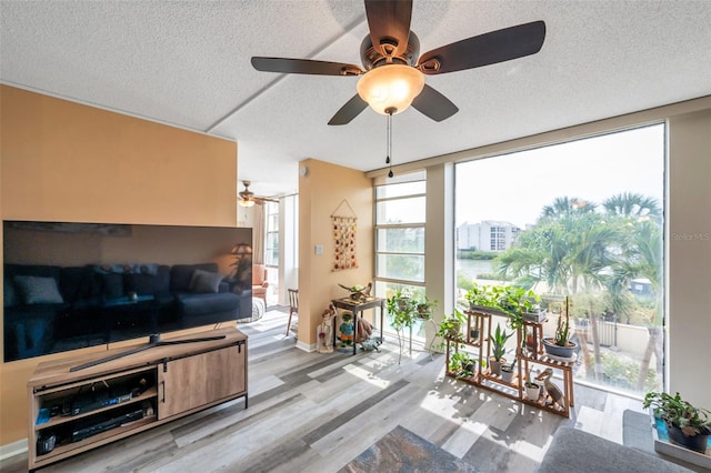 7400 Sun Island Dr S Unit 206, South Pasadena, FL 33707 - living area featuring wood finished floors, a ceiling fan, and a textured ceiling
