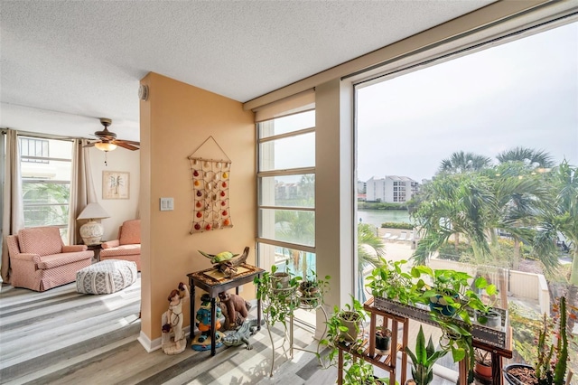 7400 Sun Island Dr S Unit 206, South Pasadena, FL 33707 - doorway to outside featuring wood finished floors, a ceiling fan, a textured ceiling, and a water view