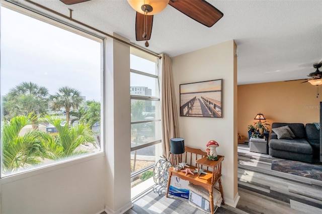 7400 Sun Island Dr S Unit 206, South Pasadena, FL 33707 - interior space featuring a ceiling fan, a textured ceiling, wood finished floors, and baseboards