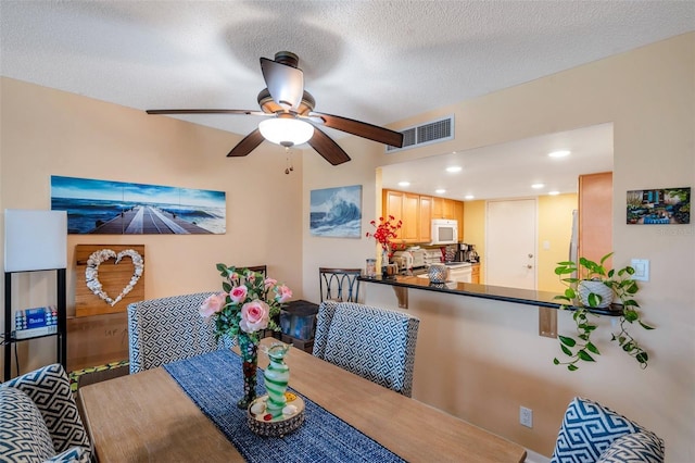 7400 Sun Island Dr S Unit 206, South Pasadena, FL 33707 - dining area with a ceiling fan, recessed lighting, and a textured ceiling
