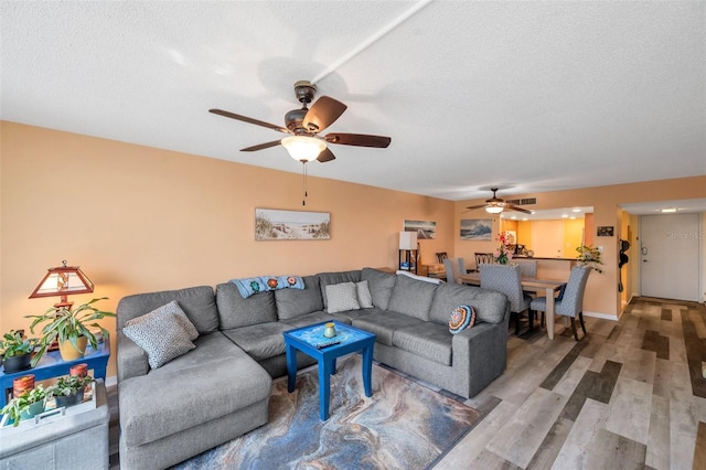 7400 Sun Island Dr S Unit 206, South Pasadena, FL 33707 - living room featuring a ceiling fan, wood finished floors, and a textured ceiling