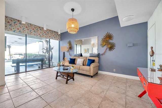7400 Sun Island Dr S Unit 206, South Pasadena, FL 33707 - living area with baseboards and light tile patterned floors
