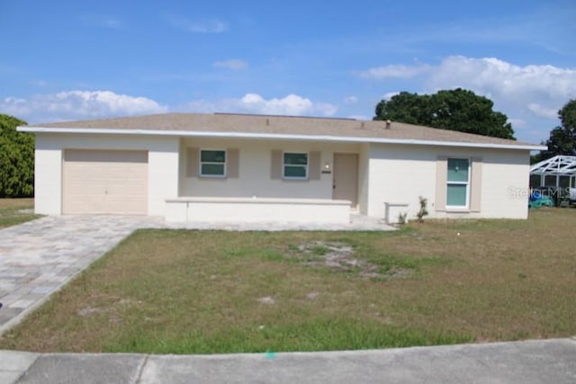 ranch-style house with a garage, stucco siding, driveway, and a front yard