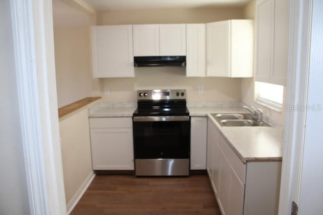 kitchen featuring stainless steel range with electric stovetop, a sink, under cabinet range hood, white cabinets, and dark wood finished floors