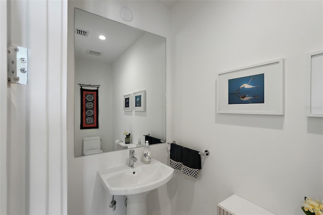 301 1st St S Unit 2305, Saint Petersburg, FL 33701 - half bathroom featuring toilet, a sink, and visible vents