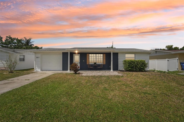 single story home with an attached garage, fence, driveway, and a front yard