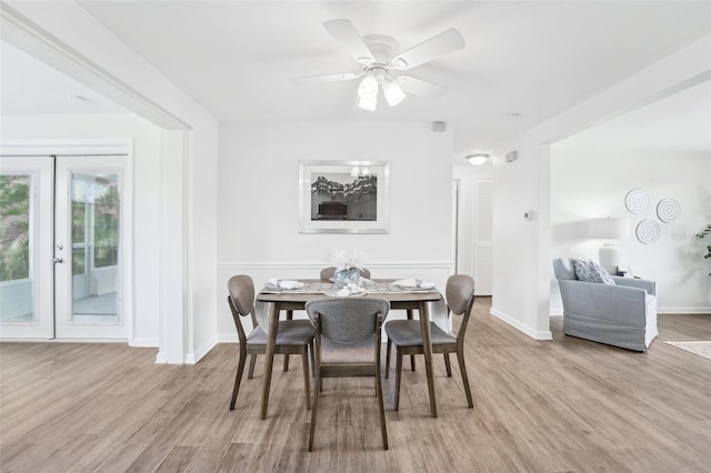 dining space featuring baseboards, a ceiling fan, and wood finished floors