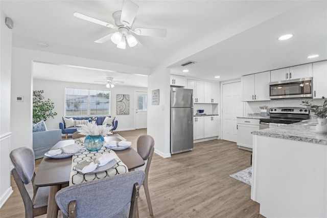 dining room featuring baseboards, ceiling fan, recessed lighting, and light wood-style flooring