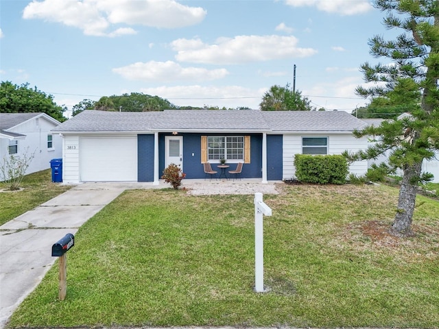 ranch-style home featuring concrete driveway, covered porch, a front yard, and a garage