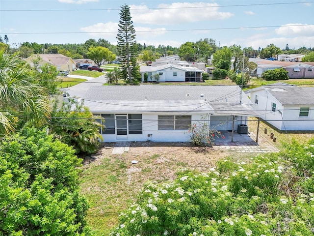back of house with fence, a residential view, central AC, a sunroom, and a patio