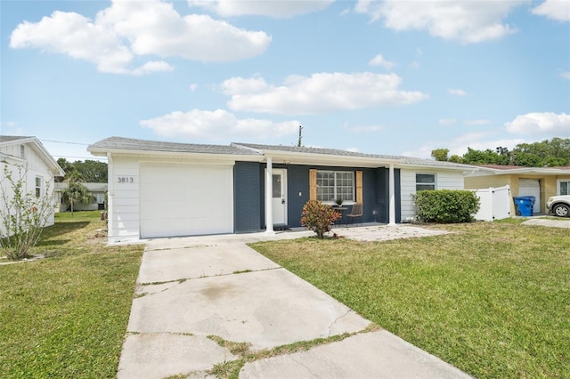 ranch-style home featuring concrete driveway, an attached garage, fence, and a front yard