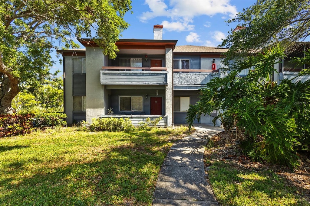 10265 Gandy Blvd N Unit 1406, Saint Petersburg, FL 33702 - townhome / multi-family property with a balcony, a chimney, and a front yard