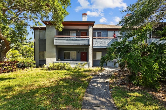 10265 Gandy Blvd N Unit 1406, Saint Petersburg, FL 33702 - townhome / multi-family property with a balcony, a chimney, and a front yard