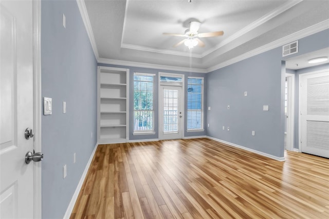 unfurnished room with baseboards, visible vents, ceiling fan, and light wood-type flooring