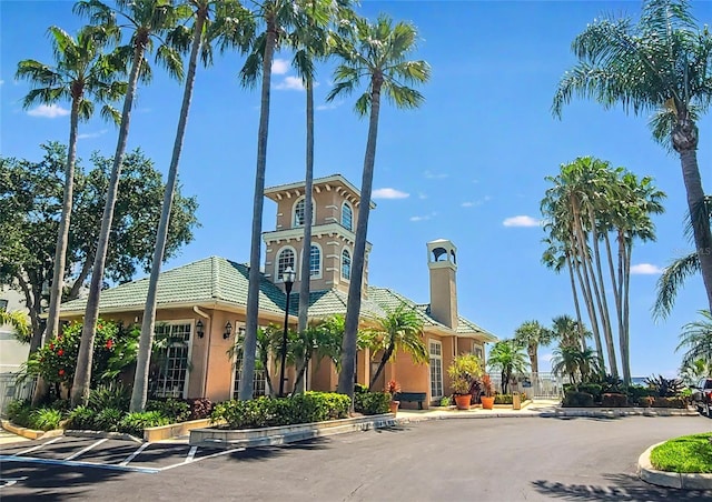 view of building exterior featuring uncovered parking
