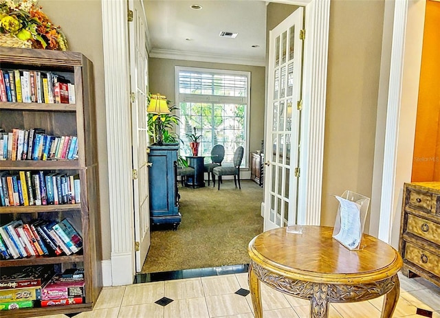 sitting room with tile patterned floors, carpet, visible vents, french doors, and crown molding