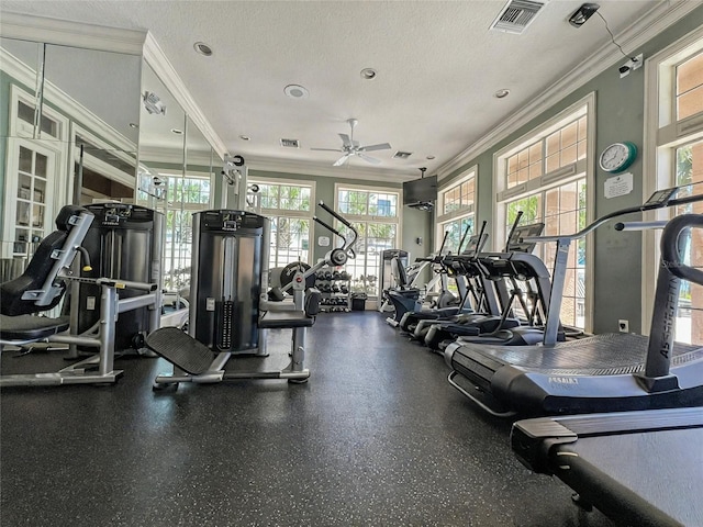 gym featuring a textured ceiling, visible vents, a ceiling fan, and ornamental molding