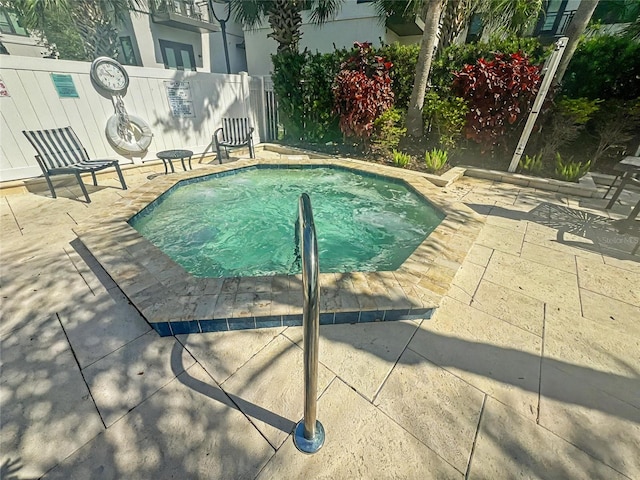 view of pool with a patio and fence