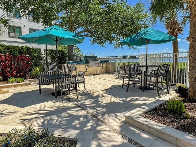 view of patio / terrace featuring fence, outdoor dining space, and area for grilling