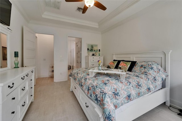 bedroom with crown molding, ceiling fan, visible vents, and a raised ceiling