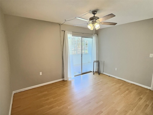 1001 77th Ave N Unit 206, Saint Petersburg, FL 33702 - spare room featuring baseboards, a ceiling fan, and light wood-style floors