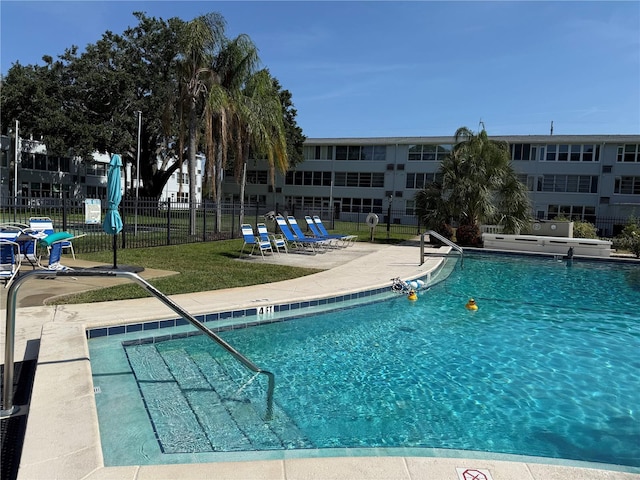 1001 77th Ave N Unit 206, Saint Petersburg, FL 33702 - community pool with a lawn, fence, and a patio area