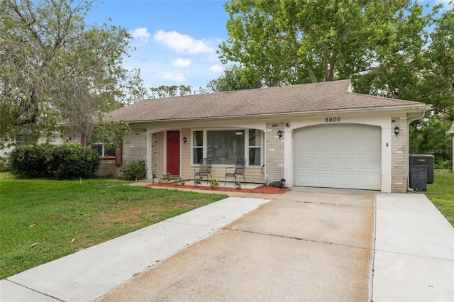 ranch-style house featuring an attached garage, driveway, a front yard, and brick siding