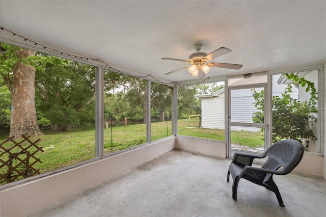 unfurnished sunroom featuring ceiling fan and healthy amount of natural light