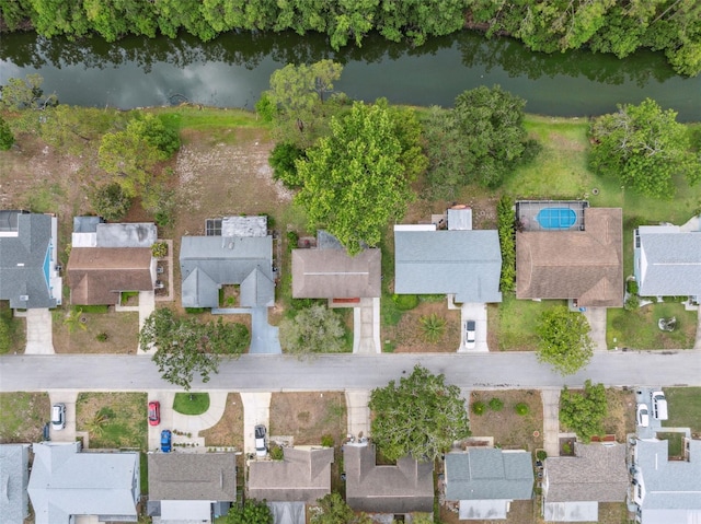 aerial view of property's location featuring a nearby body of water and nearby suburban area