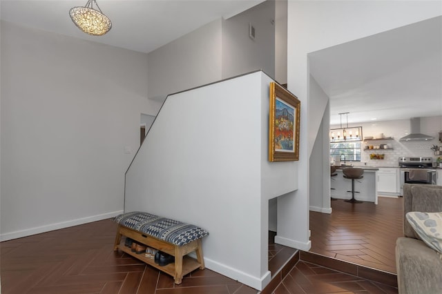 stairs with baseboards and a notable chandelier