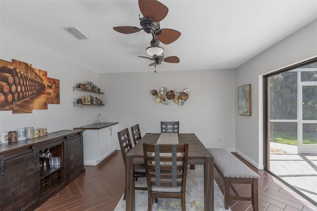dining space featuring baseboards, visible vents, and a ceiling fan