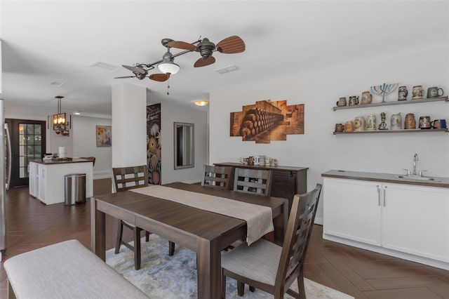 dining area with visible vents and ceiling fan with notable chandelier