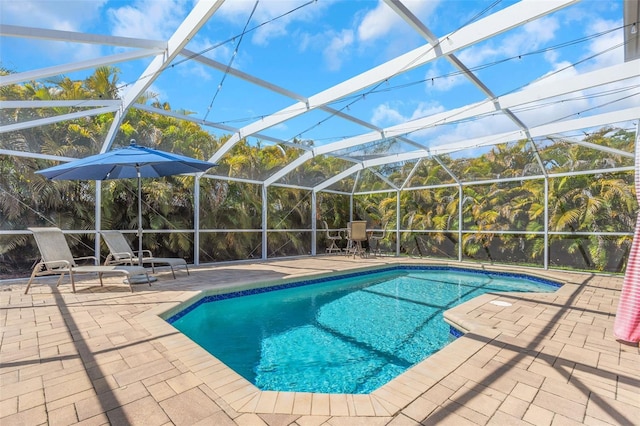 pool with a patio area and glass enclosure