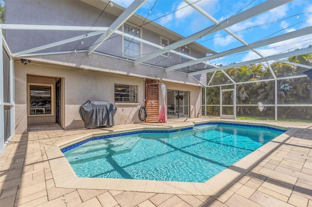 pool with a patio, a lanai, and grilling area