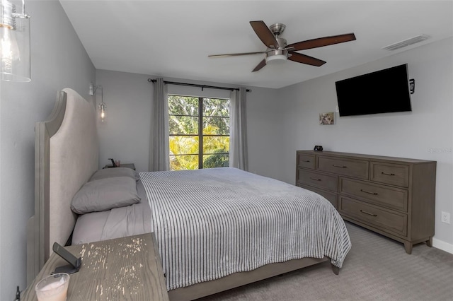 bedroom featuring visible vents, ceiling fan, and light carpet