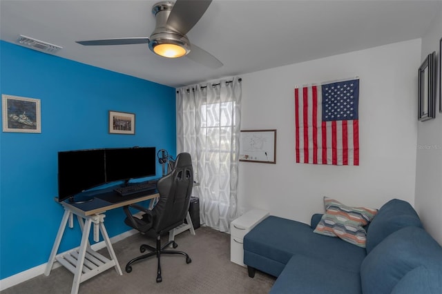 office space featuring carpet flooring, visible vents, ceiling fan, and baseboards