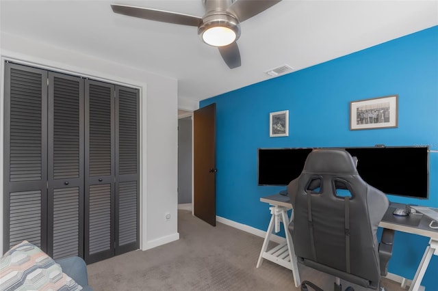 office with a ceiling fan, visible vents, carpet floors, and baseboards