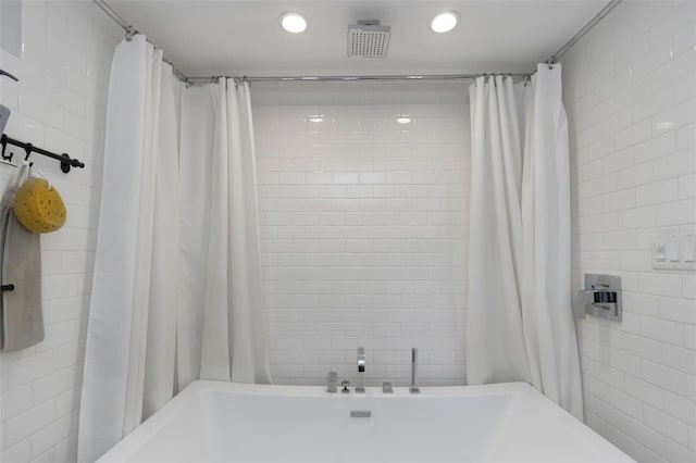 bathroom with shower / tub combo, recessed lighting, tile walls, and visible vents