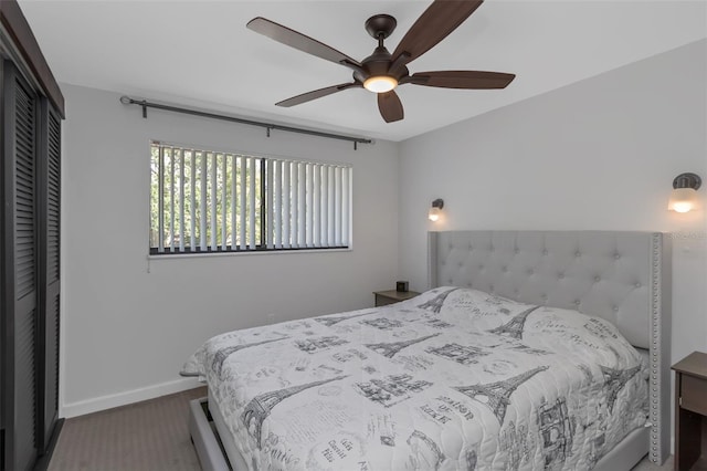 bedroom with ceiling fan, a closet, and baseboards
