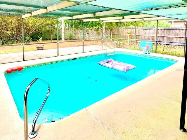 view of pool featuring a patio, a fenced in pool, a fenced backyard, and a lanai