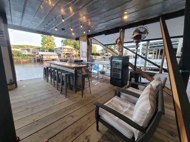 deck with a water view, boat lift, and a dock