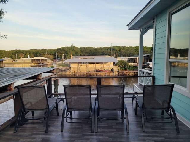 exterior space featuring a water view and outdoor dining area